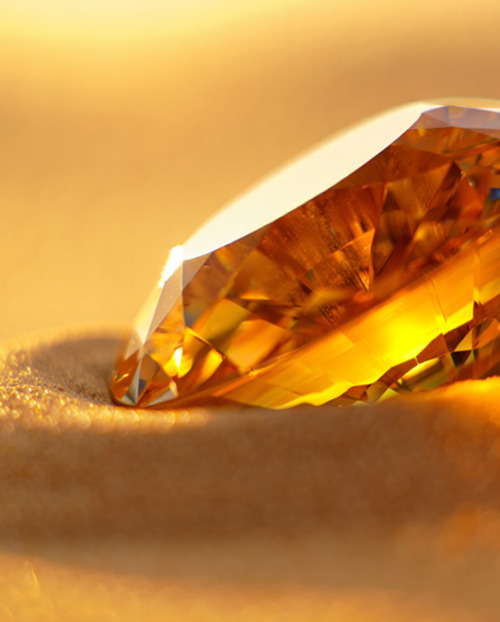 Honey Desert diamond catches the sun in the sand