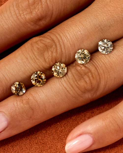 Olive hand on orange background with ombre of cut desert diamonds